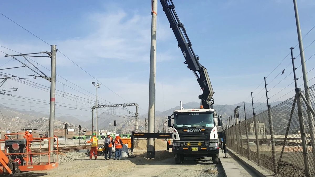 Camión grúa realizando izaje junto al cerco de una subestación